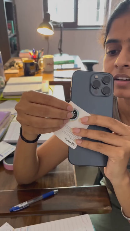 Customer applying a QuietField EMF chip to a phone