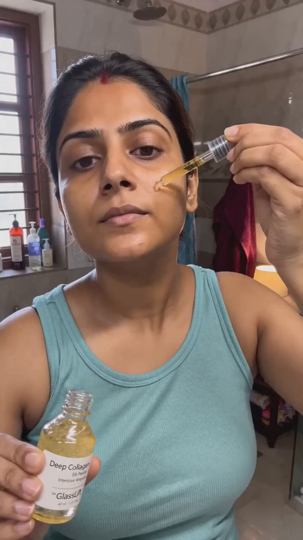 Indian woman presses golden serum drops onto cheek, glass-skin glow, real UGC